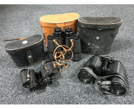 Three pairs of binoculars in leather cases, one case fitted with a compass 