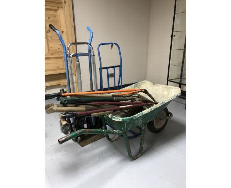 A wheel barrow with a quantity of garden tools and three sack barrows 
