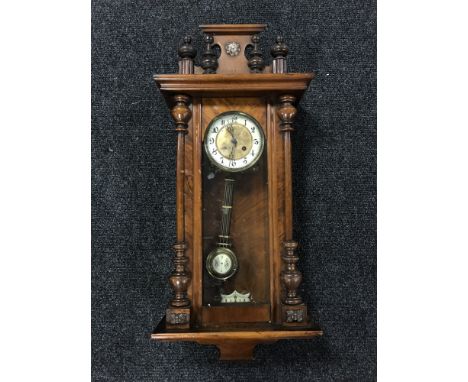 A walnut Vienna wall clock with pendulum and key