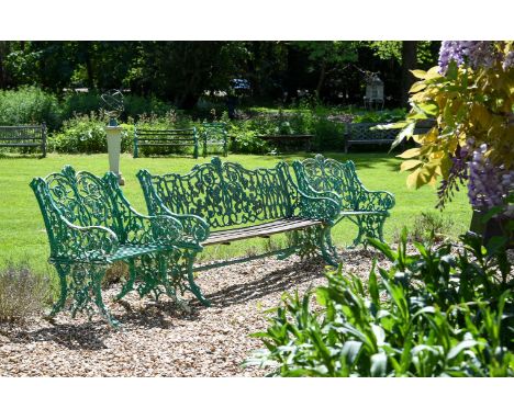 A GREEN PAINTED CAST IRON BENCH LATE 19TH CENTURY Weathered wooden slats 158.5cm wide, 89.5cm high, 58cm deep: AND A PAIR OF 