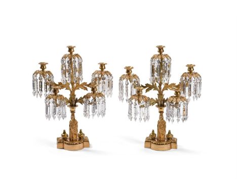 A PAIR OF FRENCH ORMOLU AND CUT GLASS CANDELABRA  LATE 19TH CENTURY  Of stepped three light form, with classical female figur