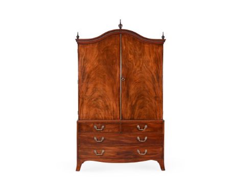 A GEORGE III MAHOGANY CLOTHES PRESS CIRCA 1790 The doors of unusual swept form 218cm high, 129cm wide, 62cm deep Condition Re