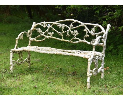A WEATHERED WHITE PAINTED CAST IRON 'GARDEN BRANCH' BENCH PROBABLY EARLY 20TH CENTURY Of conventional naturalistic rustic for