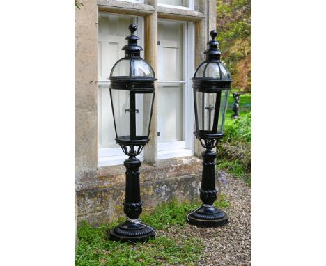 A LARGE PAIR OF BLACK PAINTED CAST IRON AND METAL GARDEN LAMPS PROBABLY EARLY OR MID 20TH CENTURY AND LATER FITTED 205cm high
