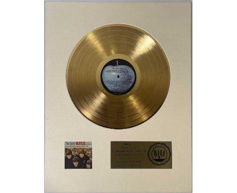 An unframed official RIAA gold disc award, presented to The Beatles to commemorate sales of more than $1million worth of 'Ear