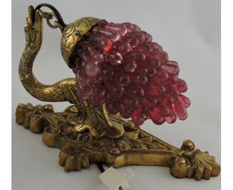 A brass and cranberry wall light in the form of a bunch of grapes.