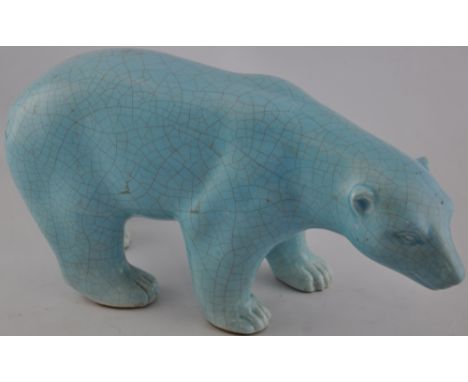 A ceramic pale blue crackle glaze figure of a bear. 