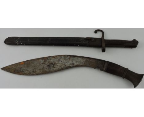 A late 19th century Italian bayonet, the torino leather scabbard dated 1884, together with a hardwood handled Kukuri. 