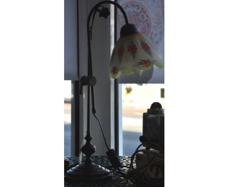 A Victorian style bronzed metal adjustable table lamp with floral decorated opaque glass shade