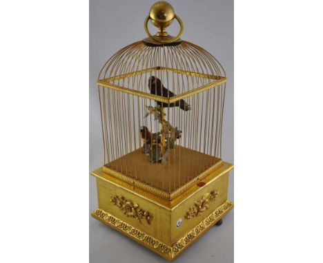A 20th Century Swiss clockwork singing bird automaton within a gilt metal and gilt jesso pine cage