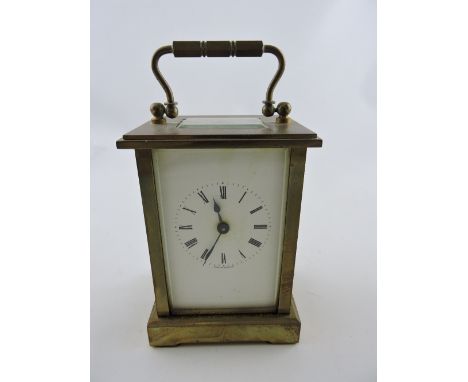 An early 20th century carriage timepiece, with a white ceramic dial set out in Roman numerals, H. 13cm