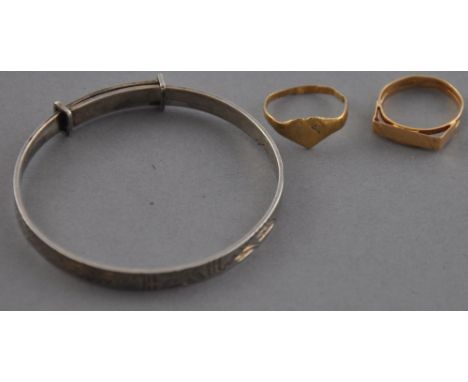 Two Victorian 9ct yellow gold child's rings together with a later child's engraved silver bangle. 