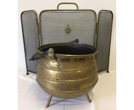 A vintage brass 3 legged cauldron style coal bucket together with a folding fire screen.  Cauldron approx. 31cm diameter x 32