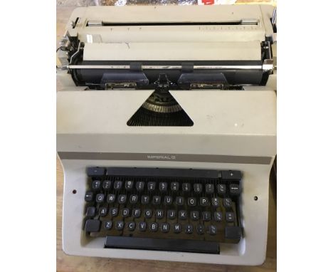 A vintage Imperial typewriter with dust cover.  