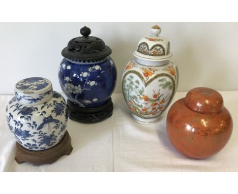 4 oriental ceramic lidded ginger jars. To include 2 with wooden stands. Tallest approx. 20cm tall.