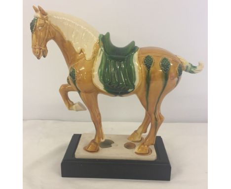 A large vintage reproduction of a Chinese Tang dynasty ceramic War Horse. With majolica style drip ware glaze.  Fine crazing 