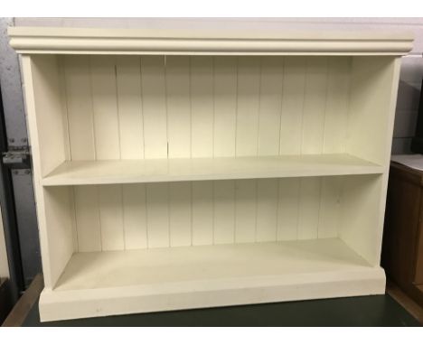 A cream painted 2 fixed shelf pine bookcase.  Approx. 117cm x 88cm tall. F