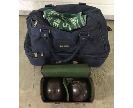 A bag containing a quantity of vintage wooden lawn bowls.  