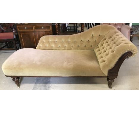 A vintage wooden framed chaise longue with button back velvet upholstery and turned legs. Some sun fading to upholstery. Appr
