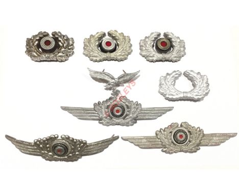 German Third Reich aluminium cap insignia.Army wreath with roundel x 3, Army wreath (one pin absent), Luftwaffe eagle with se