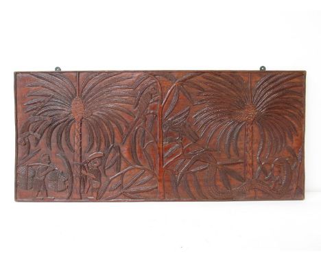 An early 20th Century Papua New Guinea carved fruitwood panel depicting coconut harvesters with onlooking monkeys, bird and s
