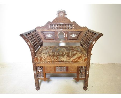 A late 19th early 20th Century Moorish armchair with mother-of-pearl inlay, straw filled seat a/f, 95cm x 81cm x 47cm