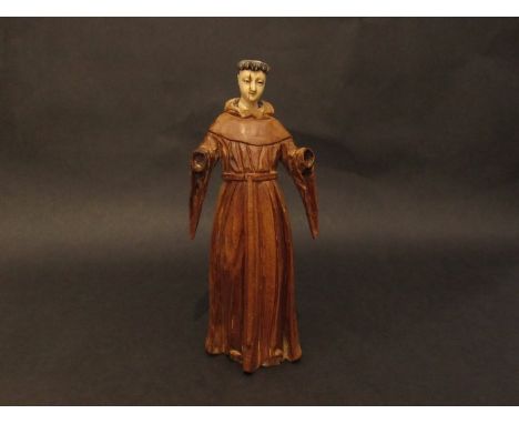 A hand carved wood figure of a monk with carved and stained ivory head (hands missing), possibly 18th Century, a/f, 30cm tall