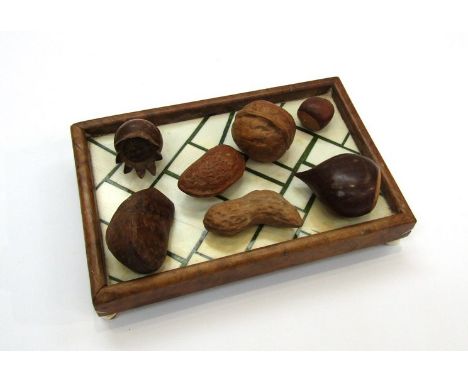 G. Bargolini: Carved mixed wood naturalistic sculpture study of seven types of nut on a wood and ivory tray, signed. 16cm lon