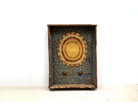 An African wood alcove shrine lining, painted with a blazing sun, rolling cloud and a starry sky, with shelf brackets to disp