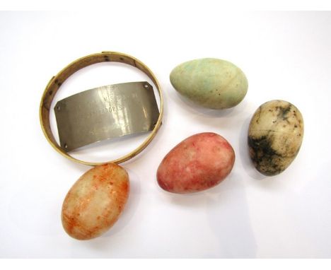 A 19th Century bone collar, polished stone eggs, metal plaque (5)