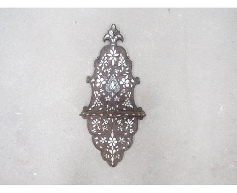 A 19th Century Anglo-Indian shaped wall hanging shelf with inset mother-of-pearl floral detail (damage present).  75cm tall x