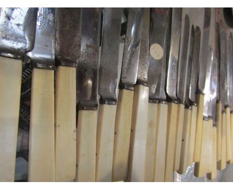 An antler handled carving knife and fork and a quantity of late 19th Century table dessert knives with ivory handles 