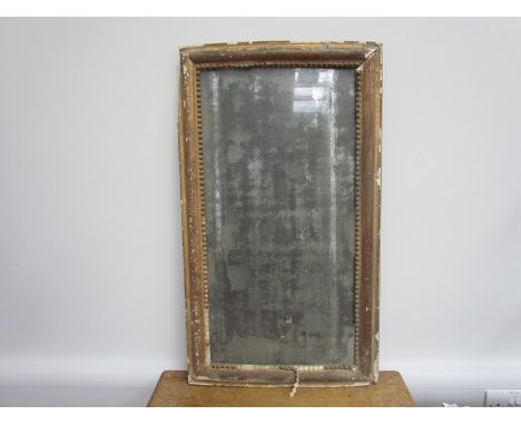 A Georgian gilt and gesso rectangular mirror with beaded border, mirror substantially deteriorated, distressed appearance.  4