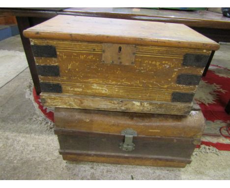 A wooden trunk and a metal trunk