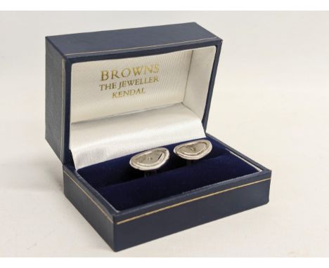 A pair of silver cufflinks. 