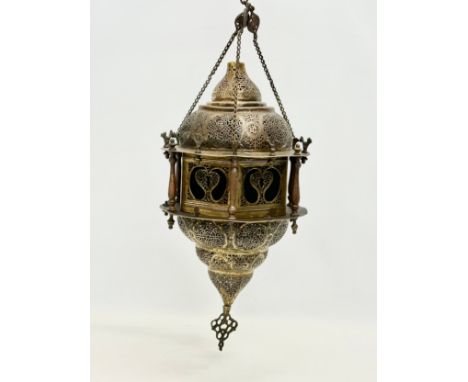 A large early 20th century Moroccan brass ceiling lantern with stained glass panels. 80cm hanging. 
