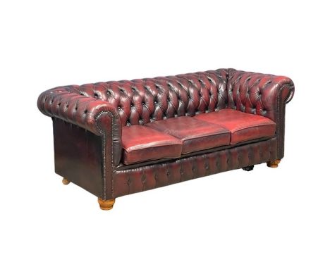 An ox-blood deep button leather 3 seater sofa. 197cm