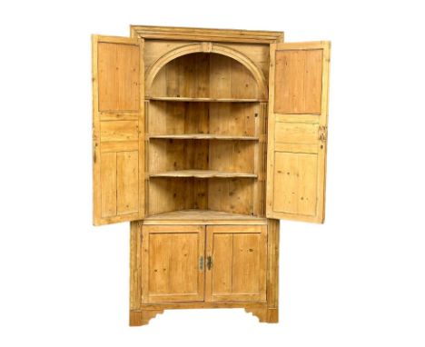 A large late George III pine corner cabinet with fitted shelves and architectural interior. Circa 1800-1820. 116x59x224cm 