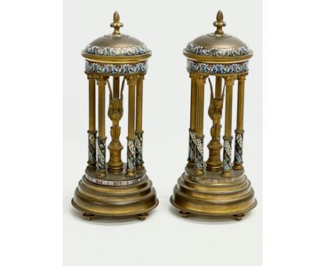 A pair of late 19th century French brass dome garnitures with Egyptian revival figures, enamel decoration and supported by Co