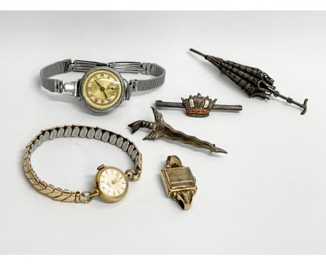 A collection of vintage watches and brooches. 