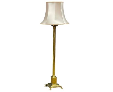 A vintage brass standard lamp with Corinthian style column on lion paw feet. 167cm 