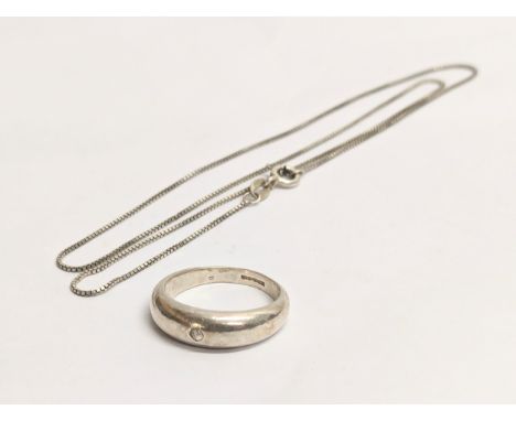 A silver necklace with a silver ring. Chain measures 22cm clasped 