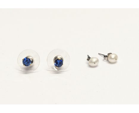 A pair of silver earrings with a pair of silver and pearl earrings. 