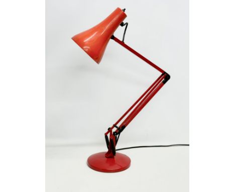 A red model 90 anglepoise lamp. 