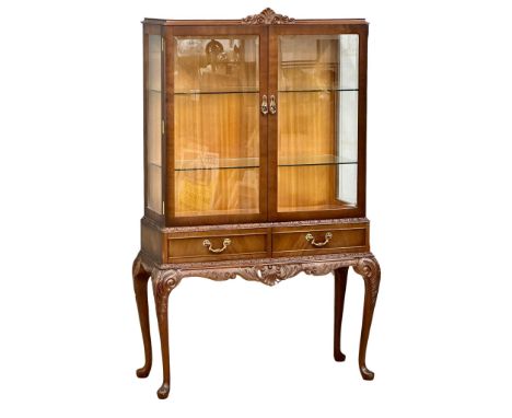 A vintage Georgian style double door display cabinet with 2 drawers on carved cabriole legs. 99x41.5x159cm 