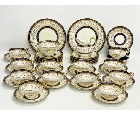 A fine 40 piece Cauldon LTD gilt and cobalt blue tea service. Early 20th century. 1905-1920. 