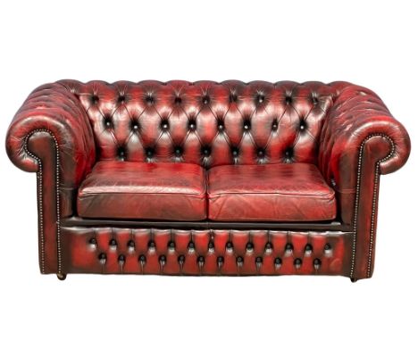 An ox-blood leather deep button 2 seater sofa. 153cm 