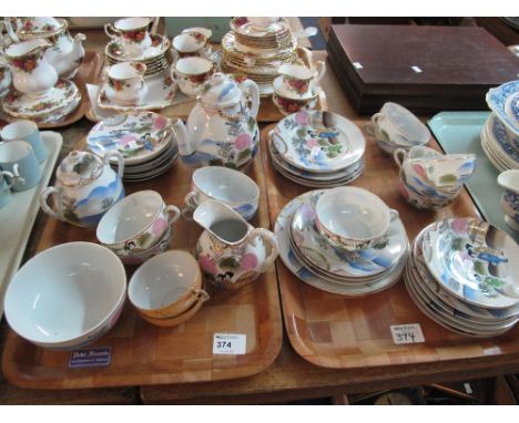 Two trays of Japanese egg shell part tea ware items decorated with figures among landscapes comprising; cups, saucers, tea po