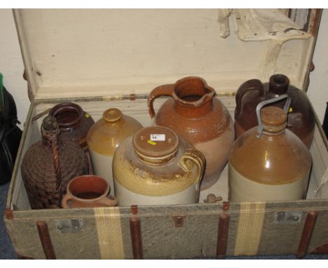 Cane bound steamer trunk containing various stoneware and glass jars, jugs and vase.