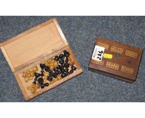 A miniature boxwood chess set in chequer board hinged box and a cribbage board box containing a pack of cards. (2)